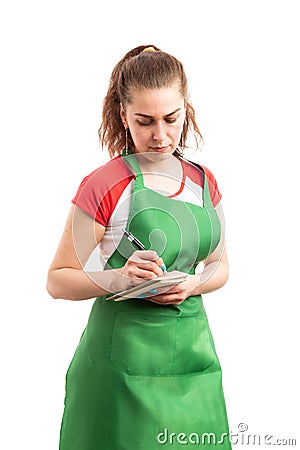 Â Woman shop assistant or retail employee writing in notebook Stock Photo